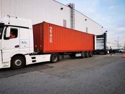  Loading wood into a container