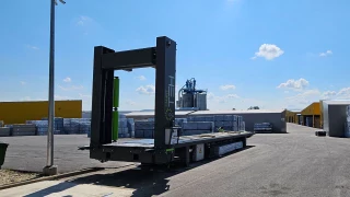 Automated container loader integrated into facility