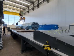 Automated container unloading system with steel pipes